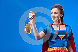 portrait of cheerful superwoman with detergent in hand