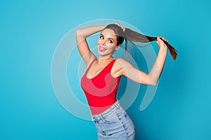 Portrait of cheerful sweet cute pretty youth girl hold hand ponytails enjoy spring anti dander silky haircare effect photo