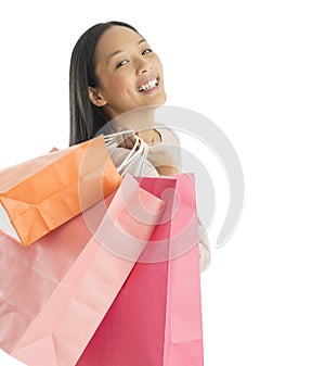 Portrait Of Cheerful Woman Carrying Shopping Bags