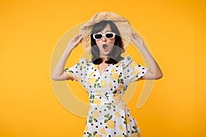 Portrait cheerful young asian woman happy smile dressing springtime female style fashion and sunglasses isolated on yellow