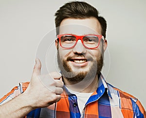 Portrait of a cheerful young bearded man showing okay gesture isolated on the white background