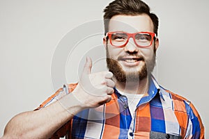 Portrait of a cheerful young bearded man showing okay gesture isolated on the white background