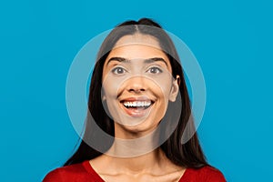 Portrait Of Cheerful Young Beautiful Woman Posing Isolated On Blue Background