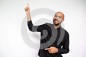 Portrait of cheerful young businessman pointing upwards