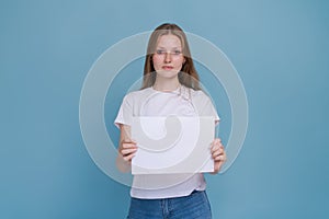 Portrait cheerful young caucasian woman smiling holding white blank banner