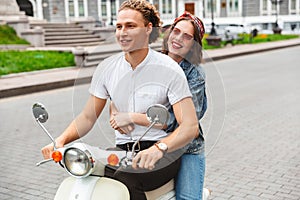 Portrait of a cheerful young couple riding