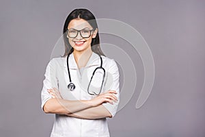 Portrait of cheerful young female doctor with stethoscope over neck looking at camera isolated on grey background