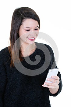 Portrait of a cheerful young girl texting in phone smartphone