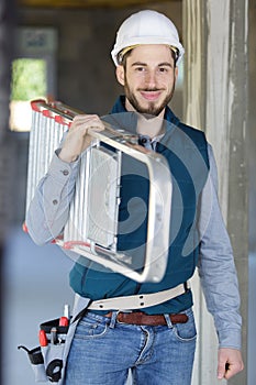 portrait cheerful young man carrying ladder