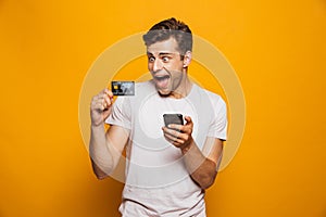 Portrait of a cheerful young man holding mobile phone