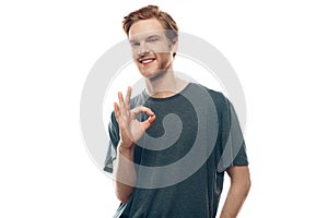 Portrait of Cheerful Young Man Showing Ok Gesture