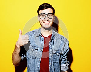 Portrait of a cheerful young man showing okay