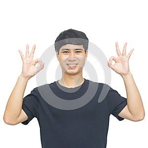 Portrait of a cheerful young man showing okay gesture isolated o