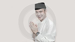 Portrait of cheerful young muslim man smiling in front of camera