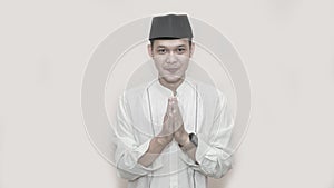 Portrait of cheerful young muslim man smiling in front of camera