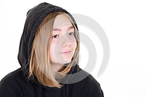 Portrait of a cheerful young teen girl in black hoodie on white background aside copyspace
