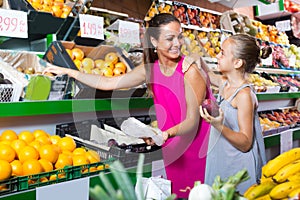 woman with child buying fruits