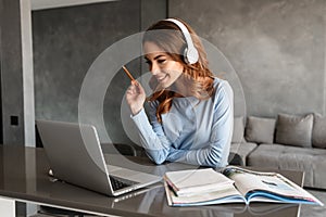 Portrait of a cheerful young woman in headphones