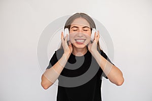 Portrait of cheerful young woman listening to music