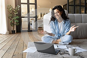 Portrait of cheerful young woman making video call, using laptop, communicating online from home, copy space