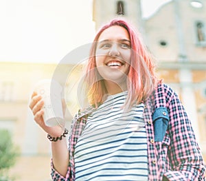 .Portrait of cheerfully smiling beautiful young female modern teenager with extraordinary hairstyle color in checkered shirt