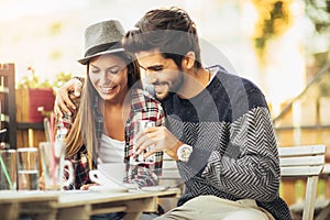 Portrait of a cheery attractive couple drinking coffee