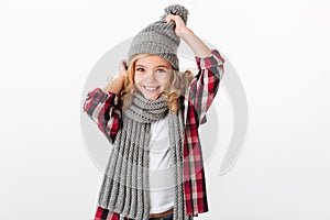 Portrait of a cheery little girl dressed in winter hat