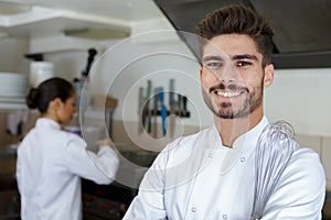 portrait chef man in kitchen with food and vegetables