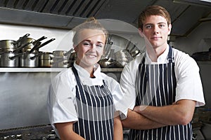 Portrait Of Chef And Trainee In Kitchen photo