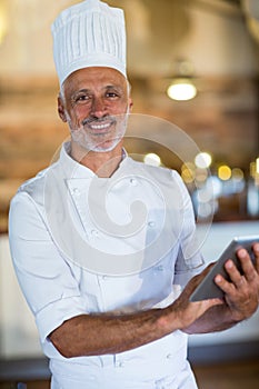 Portrait of chef using digital tablet