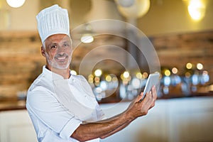 Portrait of chef using digital tablet