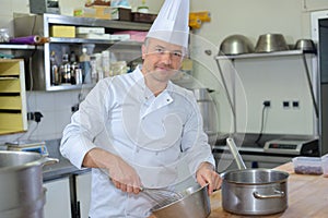 Portrait chef using whisk