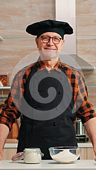 Portrait of chef wearing bonete looking at camera photo