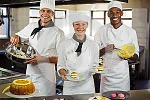 Portrait of chefs preparing a dessert