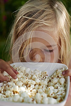 Portrait of Child Blond Girl eating popcorn