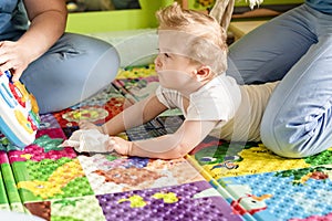 Portrait of a child with cerebral palsy on physiotherapy in a children therapy center. Boy with disability has therapy by doing