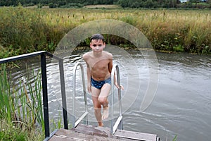 Portrait of child climbing stairs from pond