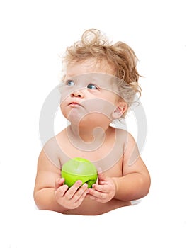 Portrait of a child curly hair eats a green Ð°pple