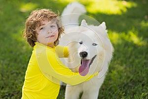 Portrait of Child and dog. Boy Playing with Husky. Kid hugging dog in the park. Kid hugs a dog in the park. Pets and