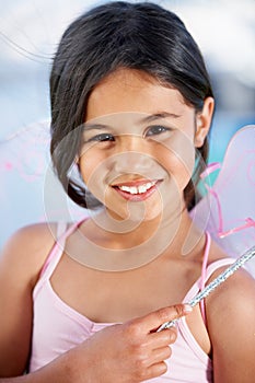 Portrait, child and a girl in a fairy costume to play a game closeup in her home for a happy childhood. Face, kids and