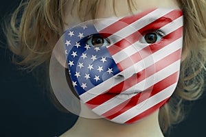 Portrait of a child with a painted American flag