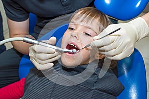 A portrait of a child patient in a dental chair in a dentistÃ¢â¬â¢s office photo