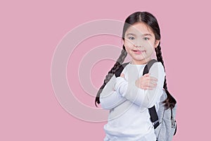 Portrait child school girl on pink background