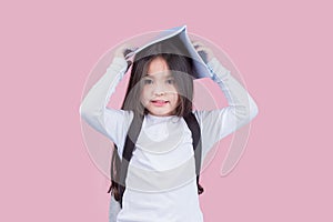 Portrait child school girl on pink background