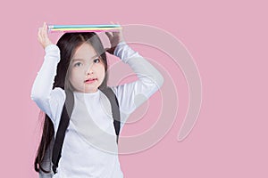 Portrait child school girl on pink background