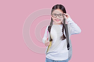 Portrait child school girl on pink background