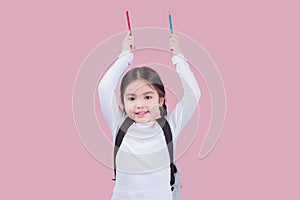 Portrait child school girl on pink background