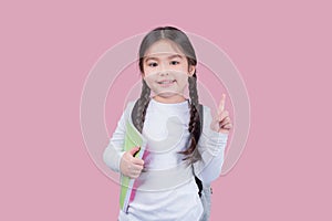 Portrait child school girl on pink background