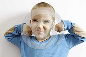 Portrait of a child showing his strength