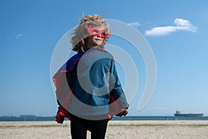 Portrait of child wearing a superhero costume. Super hero child having fun outdoors. Kids power concept.
